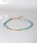 Aqua Blue Beaded Bracelet with Gold Cylinder Beads