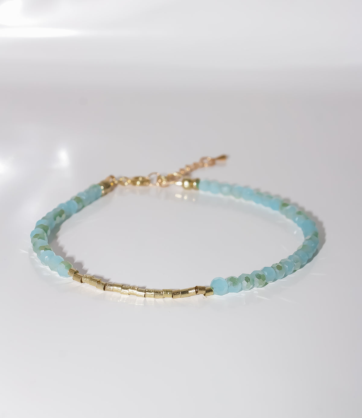 Aqua Blue Beaded Bracelet with Gold Cylinder Beads