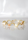 Gold Wire-Wrapped Wave Bracelet with Cream and Peach Pearls